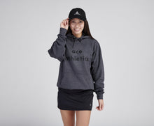Load image into Gallery viewer, Woman wearing grey sweatshirt and black tennis skirt