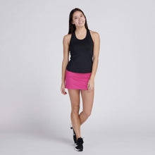 Load image into Gallery viewer, woman wearing pink tennis skirt and black top