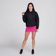 Load image into Gallery viewer, Woman wearing black sweatshirt and Fuschia tennis skirt