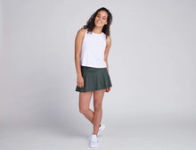 Load image into Gallery viewer, woman wearing white tank top and green tennis skirt