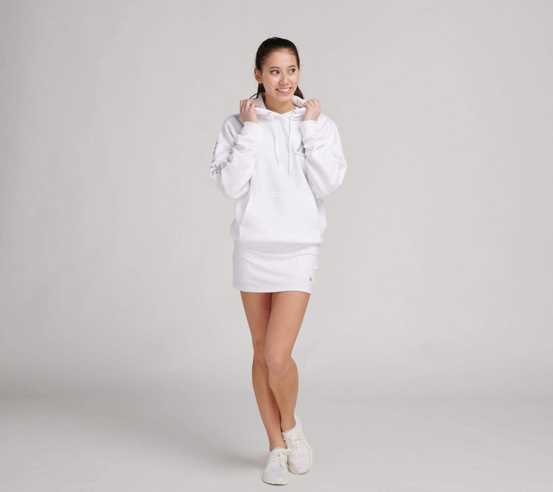 woman wearing white sweatshirt and white tennis skirt